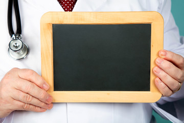 Doctor holding blank chalkboard