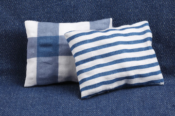 Couple of blue pillows on denim background