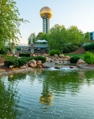 Stream flows through a Knoxville Tennessee park where the iconic sun sphere resides - obrazy, fototapety, plakaty