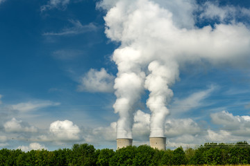 Nuclear power plant cooling towers dumping out steak with power lines
