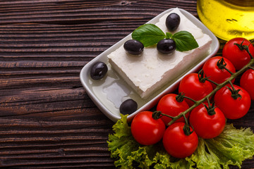 A piece of feta cheese on a wooden rustic background