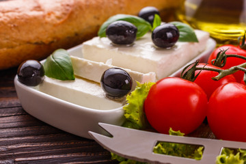 A piece of feta cheese on a wooden rustic background