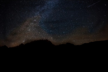 Milky Way that appears in the sky behind the profile of a dolomite mountain, South Tyrol, Italy