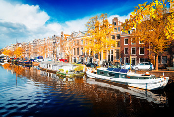 Fototapeta premium embankment of Amstel canal in Amsterdam at fall day, Netherlands