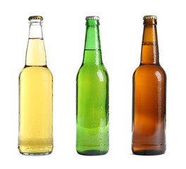 Set with different cold beer bottles on white background