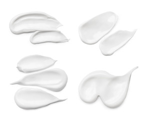 Set with different cosmetic smears on white background