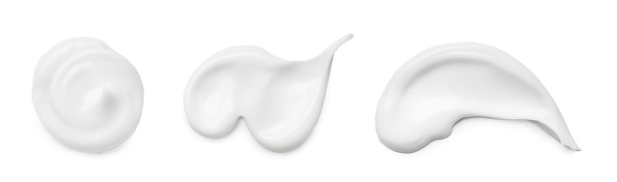 Set with different cosmetic smears on white background