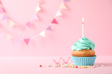 Delicious birthday cupcake with candle and space for text on color background