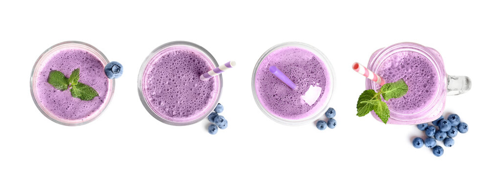 Set with delicious blueberry smoothie on white background, top view