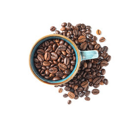 Cup and roasted coffee beans on white background, top view