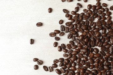 Roasted coffee beans on white background, top view