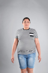 Obraz premium Fat woman on grey background. Weight loss