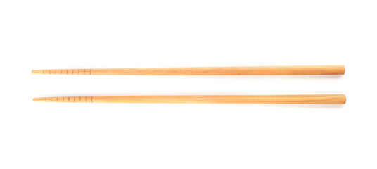 Chopsticks made of bamboo on white background, top view