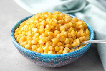 Bowl with corn kernels on grey table