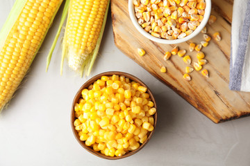 Flat lay composition with corn kernels on grey background