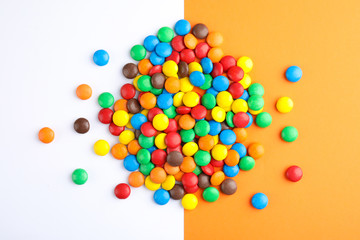 Glazed candies on color background, top view