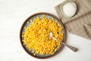 Flat lay composition with corn kernels on white wooden background