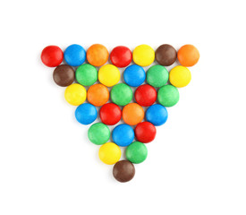 Triangle made of colorful candies on white background, top view