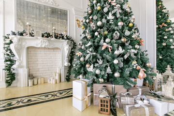 Presents and Gift boxes under Christmas Tree. Beige boxes with ribbon bow. New year decorated house interior. Winter Holiday concept.
