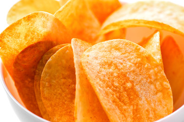 Potato chips in bowl macro shot on white background