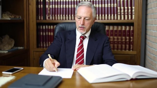 Angry businessman crumpling a sheet because of his mistakes