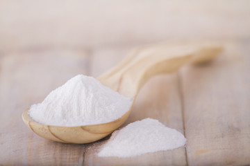 baking soda with wooden spoon on the table