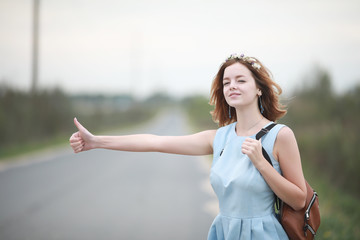 Girl in blue dress in green park