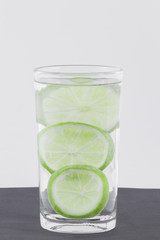 glass with water and lemon isolated on white background