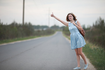 Girl in blue dress in green park