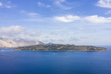 Fototapeta na wymiar Spectacular aerial view of Tavolara's island bathed by a clear and turquoise sea, Sardinia, Italy.