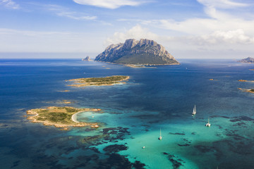 Spectacular aerial view of Tavolara's island bathed by a clear and turquoise sea, Sardinia, Italy. - obrazy, fototapety, plakaty