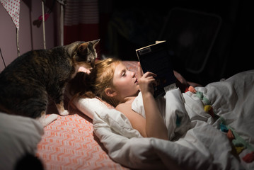 Boy reading to cat