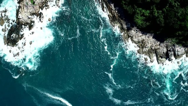 Aerial view drone shot of seascape scenic wave crashing on the rocks