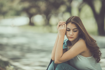 Beautiful thai woman very sad from unrequited love,rethink,think over,vintage style,dark tone,broken heart,asian girl