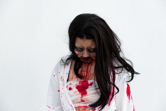 Portrait of asian woman make up ghost face with blood on white background,Horror scene,Scary background,Halloween poster,Thailand people