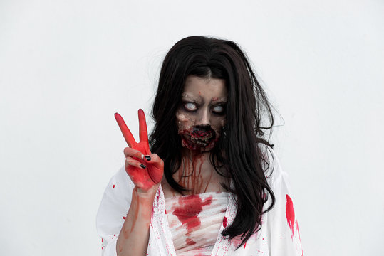 Portrait of asian woman make up ghost face with blood on white background,Horror scene,Scary background,Halloween poster,Thailand people
