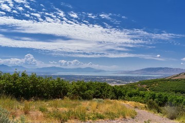 Panoramic Landscape view from Travers Mountain of Provo, Utah County, Utah Lake and Wasatch Front Rocky Mountains, and Cloudscape. Utah, USA.
