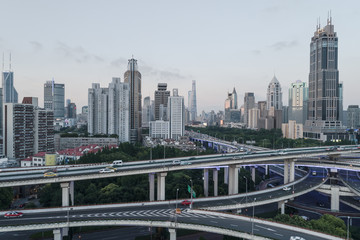 Fototapeta na wymiar aerial view of buildings and highway interchange at dusk in Shanghai city