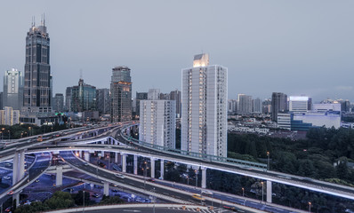 Fototapeta na wymiar aerial view of buildings and highway interchange at dusk in Shanghai city