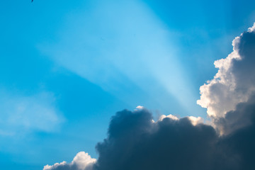Fototapeta na wymiar Sun rays through clouds like an dramatic explosion , power nature background. Sky landscape