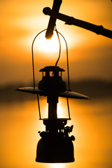 Lantern hang outdoor, sunlight reflection over water on background