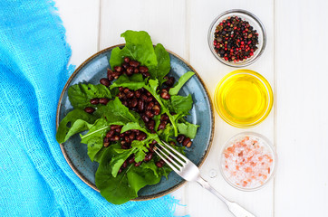 Vegetarian salad of red beans and arugula
