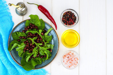 Vegetarian salad of red beans and arugula
