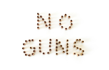 The words 'No Guns' spelled out with 9 millimeter bullets isolated on white