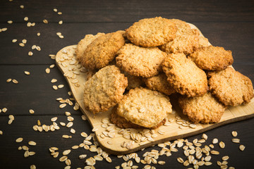 Many healthy oatmeal cookies on wooden background