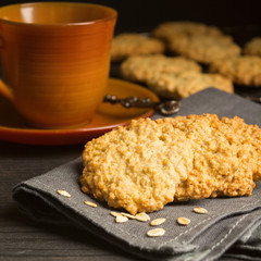 Sweet cookies with oat on tissue with tea or coffee
