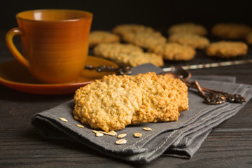 Sweet cookies with oat on tissue with tea or coffee