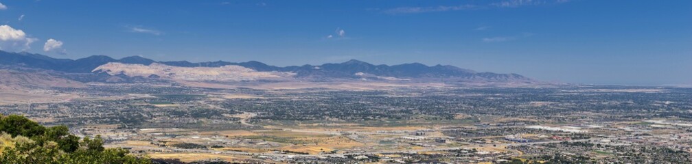 Panoramic Landscape view of Wasatch Front Rocky and Oquirrh Mountains, Rio Tinto Bingham Copper Mine, Great Salt Lake Valley in summer with Cloudscape. Utah, USA.