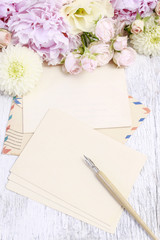Vintage stationery set and pastel colors flowers around