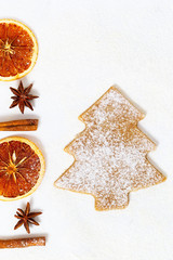Christmas decoration. Christmas food background. New Year ginger biscuit in shape of Christmas Tree with Cinnamon sticks, dried orange slices, anise stars.